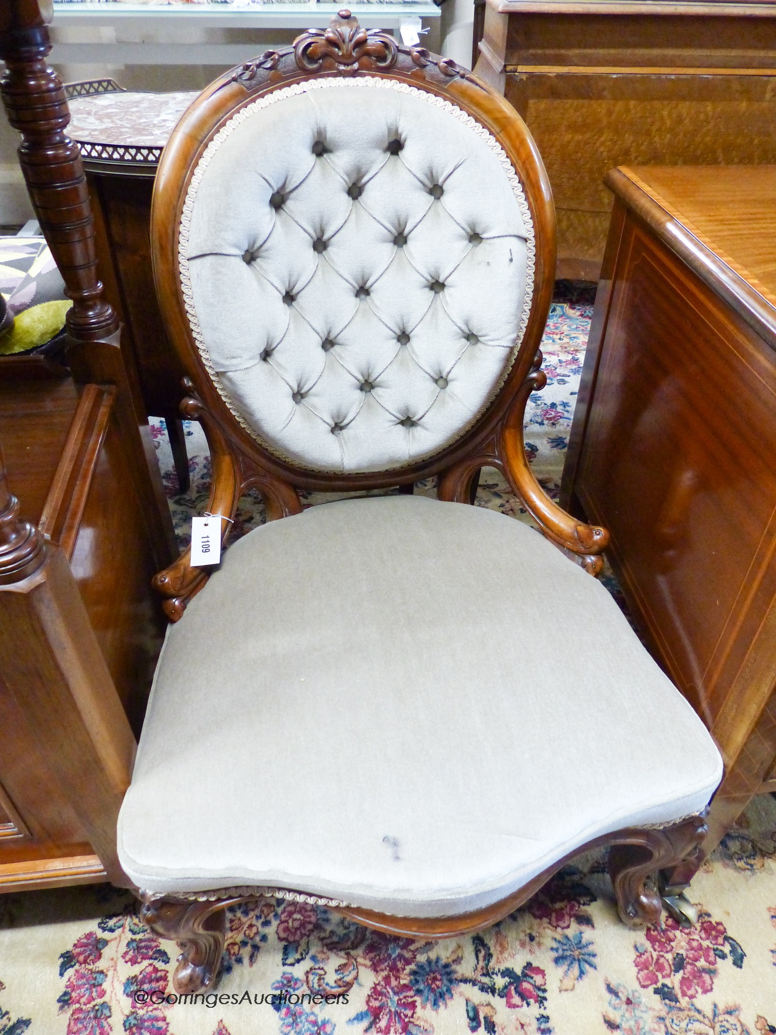 A Victorian walnut spoon back nursing chair upholstered in buttoned pale green dralon